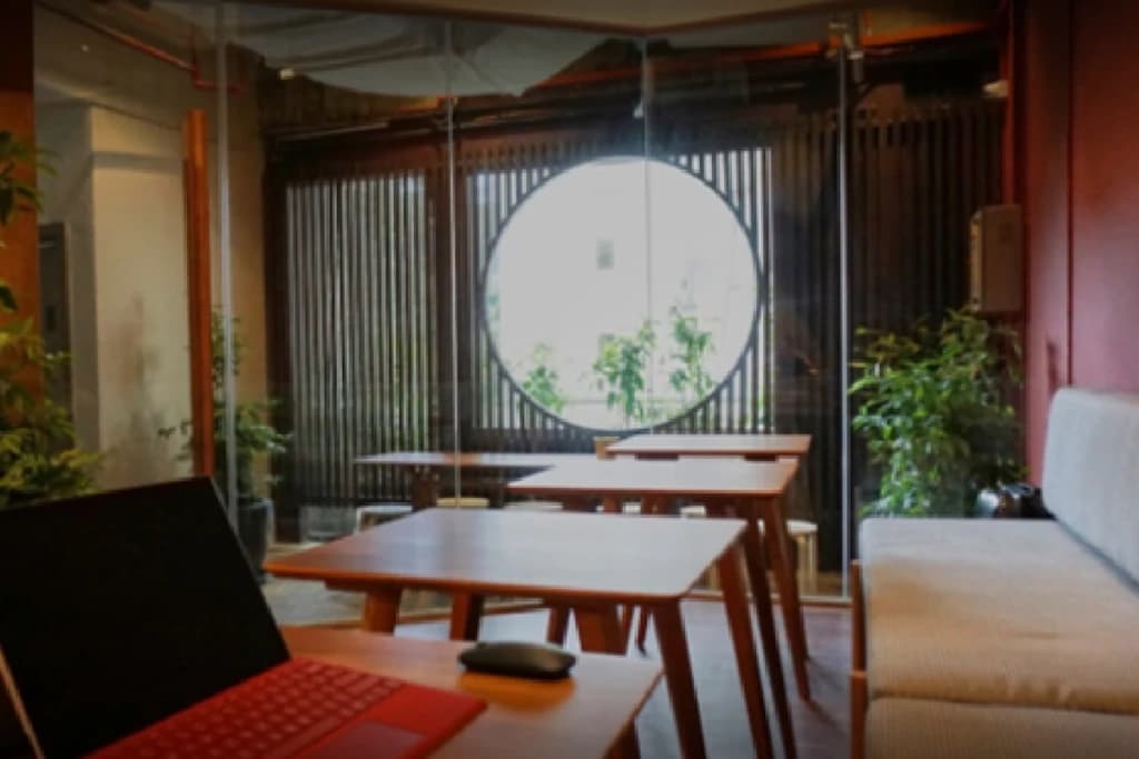 A laptop and seating in a shared workplace lounge