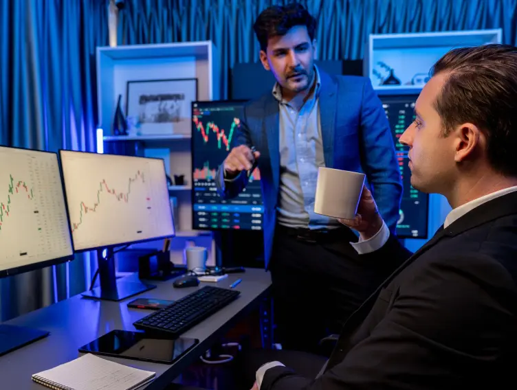 Two stock exchange traders discussing a dynamic investment graph