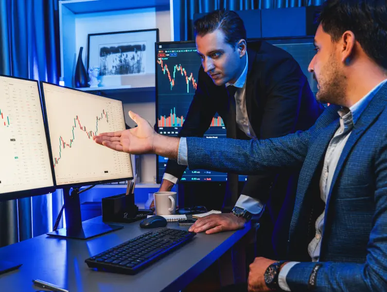 Stock exchange traders looking at a high profit chart
